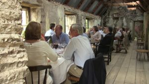 People Dining in a rustic barn at an opera festival